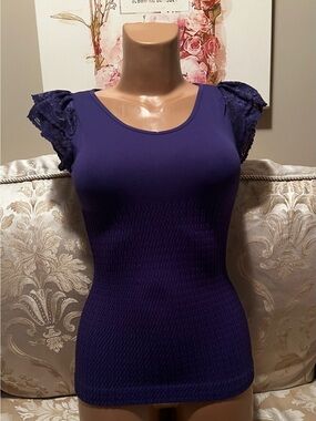 Purple body hugging scoop-neck top with lace capped sleeves